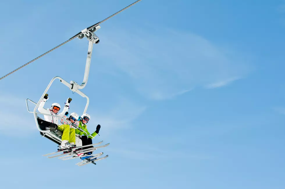 Happy skiers on ski lift - space for text